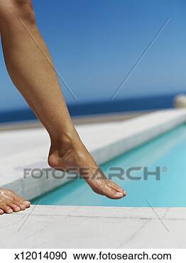 Stock Photography - woman dipping 
her feet in a 
swimming pool. 
fotosearch - search 
stock photos, 
pictures, images, 
and photo clipart