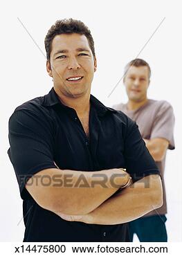 Stock Photography - portrait of a 
mid adult man 
smiling with a 
young man standing 
behind. fotosearch 
- search stock 
photos, pictures, 
images, and photo 
clipart
