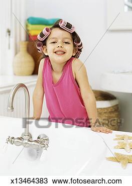 Stock Photo - girl with curlers 
in her hair leaning 
against a bathroom 
sink. fotosearch 
- search stock 
photos, pictures, 
images, and photo 
clipart
