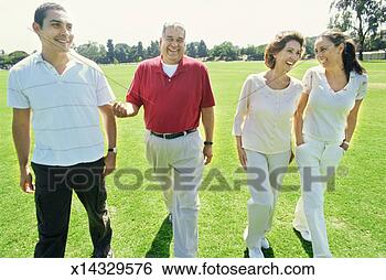 Stock Photo - mid adult couple 
and a mature couple 
walking in a park. 
fotosearch - search 
stock photos, 
pictures, images, 
and photo clipart