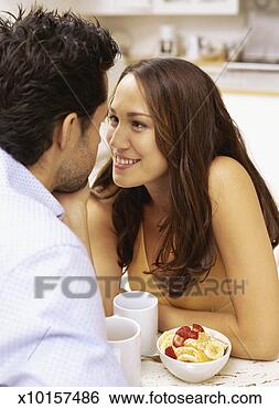 Stock Photo - close-up of a 
young couple sitting 
face to face in 
the kitchen. fotosearch 
- search stock 
photos, pictures, 
images, and photo 
clipart