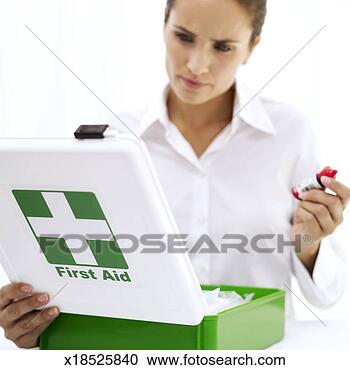 Stock Photography - portrait of a 
young woman looking 
into a first aid 
medical kit. fotosearch 
- search stock 
photos, pictures, 
images, and photo 
clipart