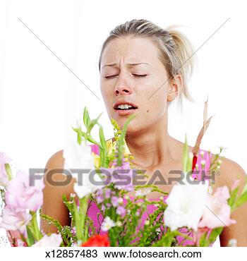 Stock Photo - young woman sneezing 
due to pollen 
dust from flowers. 
fotosearch - search 
stock photos, 
pictures, images, 
and photo clipart