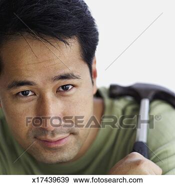 Stock Photograph - close-up of a 
mid adult man 
holding a hammer. 
fotosearch - search 
stock photos, 
pictures, images, 
and photo clipart