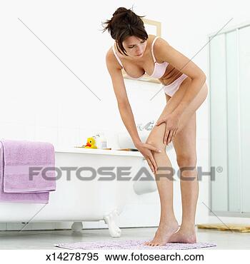 Stock Image - young woman massaging 
her leg in a bathroom. 
fotosearch - search 
stock photos, 
pictures, images, 
and photo clipart
