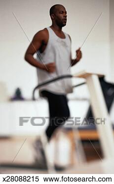 Stock Image - man running on 
a treadmill in 
physical therapy. 
fotosearch - search 
stock photos, 
pictures, images, 
and photo clipart