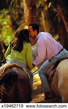 Stock Photograph - couple kissing 
while horseback 
riding. fotosearch 
- search stock 
photos, pictures, 
images, and photo 
clipart
