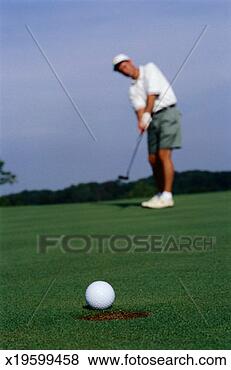 Stock Photo - golfer putting 
a golf ball. fotosearch 
- search stock 
photos, pictures, 
images, and photo 
clipart