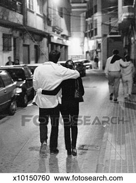 Stock Photography - couple, arm in 
arm, walking in 
street, spain. 
fotosearch - search 
stock photos, 
pictures, images, 
and photo clipart