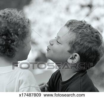 Stock Photograph - 7 year old boy 
leaning in to 
kiss girl on cheek. 
fotosearch - search 
stock photos, 
pictures, images, 
and photo clipart