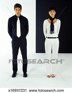 Stock Photography - man and woman, 
wearing contrasting 
colors, stand 
side by side. 
fotosearch - search 
stock photos, 
pictures, images, 
and photo clipart