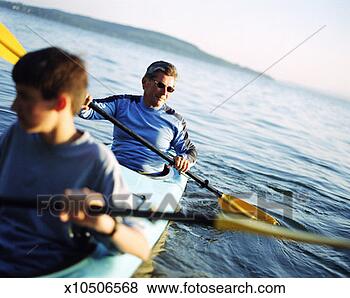 Stock Photo - father and son 
paddle sea kayak. 
fotosearch - search 
stock photos, 
pictures, images, 
and photo clipart