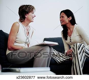 Picture - two women on sofa, 
mature woman laughing. 
fotosearch - search 
stock photos, 
pictures, images, 
and photo clipart