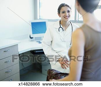 Stock Photo - young female doctor 
sitting in exam 
room with female 
patient. fotosearch 
- search stock 
photos, pictures, 
images, and photo 
clipart