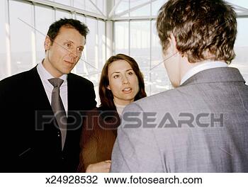 Stock Photo - three business 
people in discussion, 
close-up. fotosearch 
- search stock 
photos, pictures, 
images, and photo 
clipart