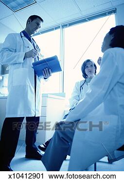 Stock Photography - three doctors 
discussing a medical 
record. fotosearch 
- search stock 
photos, pictures, 
images, and photo 
clipart