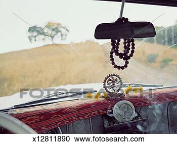 Stock Photography - hindu figure and 
yin yang symbol 
on dashboard of 
car. fotosearch 
- search stock 
photos, pictures, 
images, and photo 
clipart