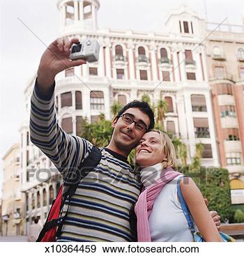 Stock Photograph - couple taking 
self-portrait 
in front of sights 
in spain, high 
section. fotosearch 
- search stock 
photos, pictures, 
images, and photo 
clipart