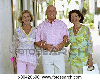 Stock Photo - mature man and 
two mature women 
linking arms outdoors, 
portrait. fotosearch 
- search stock 
photos, pictures, 
images, and photo 
clipart