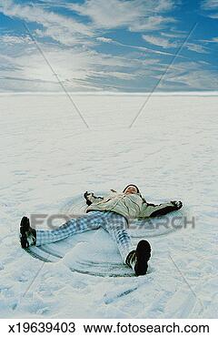 Stock Photo - girl (11-13) lying 
in snow making 
snow angel, elevated 
view. fotosearch 
- search stock 
photos, pictures, 
images, and photo 
clipart