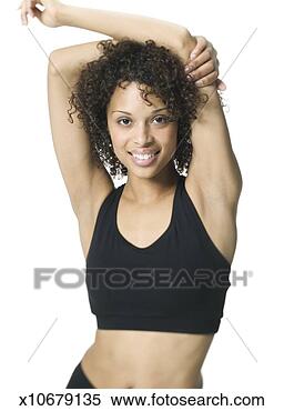 Stock Image - medium shot of 
a young adult 
woman in a black 
workout outfit 
as she. fotosearch 
- search stock 
photos, pictures, 
images, and photo 
clipart
