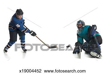Stock Photo - a caucasian male 
hockey player 
in a blue jersey 
skates and shoots 
his. fotosearch 
- search stock 
photos, pictures, 
images, and photo 
clipart