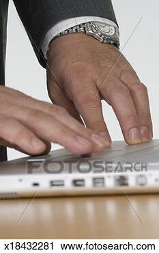 Stock Photography - hands of businessman 
typing on laptop 
computer, close-up. 
fotosearch - search 
stock photos, 
pictures, images, 
and photo clipart