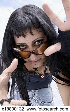 Stock Photo - low angle view 
of a young woman 
wearing sunglasses. 
fotosearch - search 
stock photos, 
pictures, images, 
and photo clipart