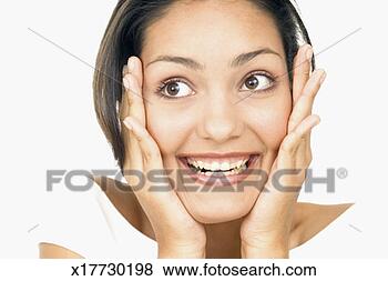 Stock Photo - portrait of a 
young woman holding 
her face in surprise. 
fotosearch - search 
stock photos, 
pictures, images, 
and photo clipart