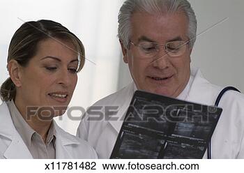 Stock Photo - two doctors viewing 
a scan together. 
fotosearch - search 
stock photos, 
pictures, images, 
and photo clipart