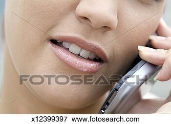 Picture - young woman on 
cell phone, extreme 
close-up. fotosearch 
- search stock 
photos, pictures, 
images, and photo 
clipart