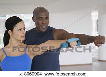 Stock Photo - young woman exercising 
with a trainer. 
fotosearch - search 
stock photos, 
pictures, images, 
and photo clipart