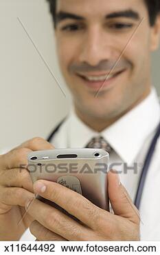 Stock Photo - doctor working 
on computer device, 
close-up. fotosearch 
- search stock 
photos, pictures, 
images, and photo 
clipart