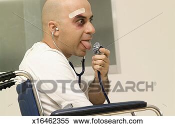 Stock Image - male patient sitting 
in a wheel chair 
sticking his tongue 
out in. fotosearch 
- search stock 
photos, pictures, 
images, and photo 
clipart