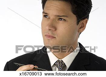 Stock Photo - portrait of young 
businessman holding 
pen and gazing 
off, close-up. 
fotosearch - search 
stock photos, 
pictures, images, 
and photo clipart
