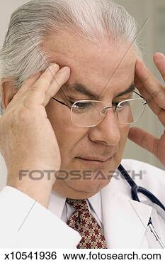 Stock Photo - doctor with headache 
and massaging 
temples, close-up. 
fotosearch - search 
stock photos, 
pictures, images, 
and photo clipart