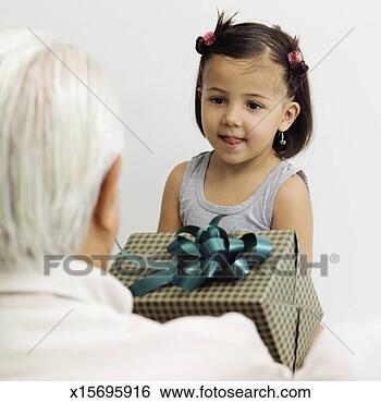 Stock Photo - grandfather and 
granddaughter 
with gift, close-up, 
rear view. fotosearch 
- search stock 
photos, pictures, 
images, and photo 
clipart