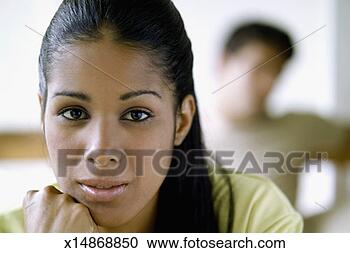 Stock Photography - pensive young 
woman and person 
in background, 
close-up. fotosearch 
- search stock 
photos, pictures, 
images, and photo 
clipart