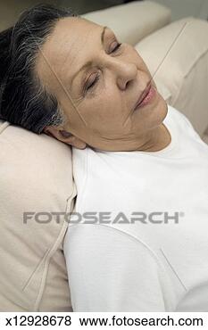 Stock Photo - portrait of senior 
woman sitting 
up and sleeping 
on sofa, close-up. 
fotosearch - search 
stock photos, 
pictures, images, 
and photo clipart