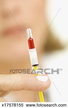 Stock Image - woman holding 
out syringe,  
close-up,  focus 
on finger and 
syringe. fotosearch 
- search stock 
photos, pictures, 
images, and photo 
clipart