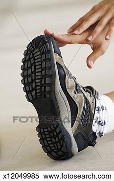 Stock Image - woman stretching 
and touching shoe, 
close-up, part 
of. fotosearch 
- search stock 
photos, pictures, 
images, and photo 
clipart