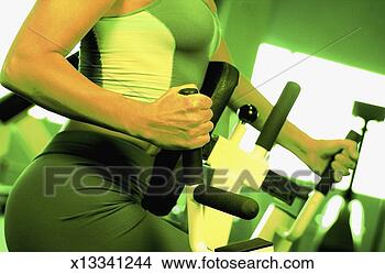 Stock Photo - midsection of 
woman on exercise 
equipment, extreme 
close-up. fotosearch 
- search stock 
photos, pictures, 
images, and photo 
clipart