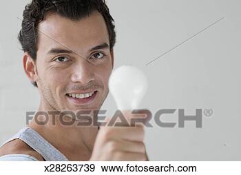 Stock Photograph - portrait of a 
mid adult man 
holding a light 
bulb. fotosearch 
- search stock 
photos, pictures, 
images, and photo 
clipart