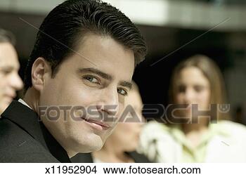 Stock Photo - smiling businessman 
looking at camera 
with defocused 
other business. 
fotosearch - search 
stock photos, 
pictures, images, 
and photo clipart