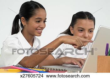 Stock Photo - two girls using 
laptop computer, 
 with one pointing 
at computer. fotosearch 
- search stock 
photos, pictures, 
images, and photo 
clipart