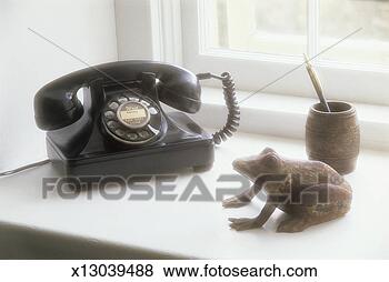 Stock Photo - 'old fashioned 
telephone on window 
sill,  model frog 
and pen holder. 
fotosearch - search 
stock photos, 
pictures, images, 
and photo clipart