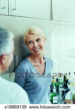 Stock Photograph - mature woman listening 
to a mature man 
in the foreground. 
fotosearch - search 
stock photos, 
pictures, images, 
and photo clipart
