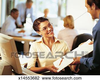 Stock Photo - office worker 
receiving a parcel 
from a colleague 
in an office. 
fotosearch - search 
stock photos, 
pictures, images, 
and photo clipart