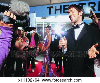 Stock Photo - tv reporter being 
broadcasted at 
a film industry 
night in front 
of a. fotosearch 
- search stock 
photos, pictures, 
images, and photo 
clipart