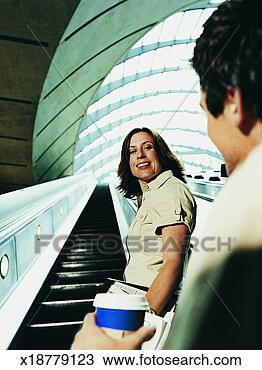 Stock Photo - man chatting up 
a businesswoman 
on an escalator. 
fotosearch - search 
stock photos, 
pictures, images, 
and photo clipart